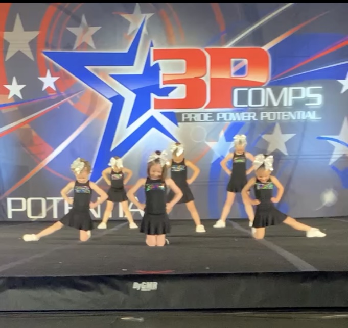 Mini and Tiny Novice All Star Cheer athlete smiling